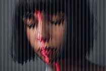 Portrait with neon red light slicing through vertical line distortion effect