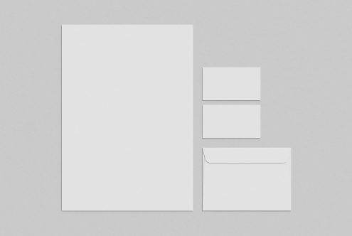 Stationery mockup with A4 paper, business cards, and envelope on a grey background for presentation and portfolio designs.