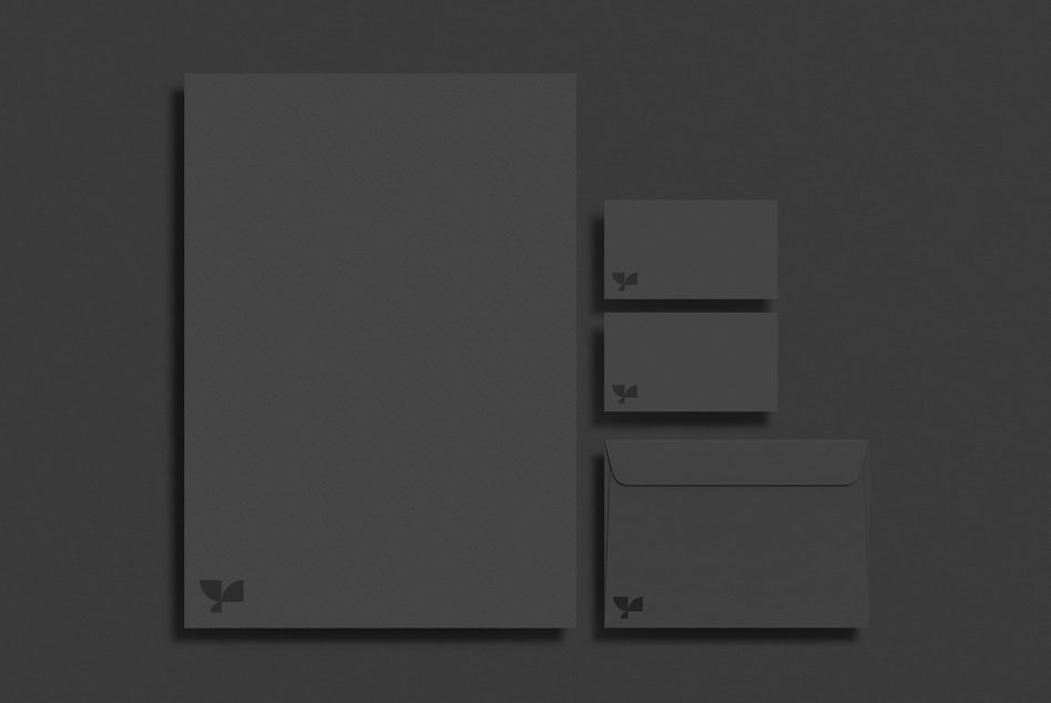 Stationery set with folder, business cards, envelope on dark backdrop