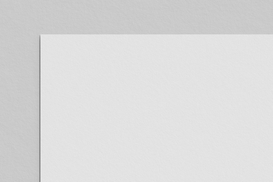 Blank white paper sheet with soft edge shadow on neutral backdrop