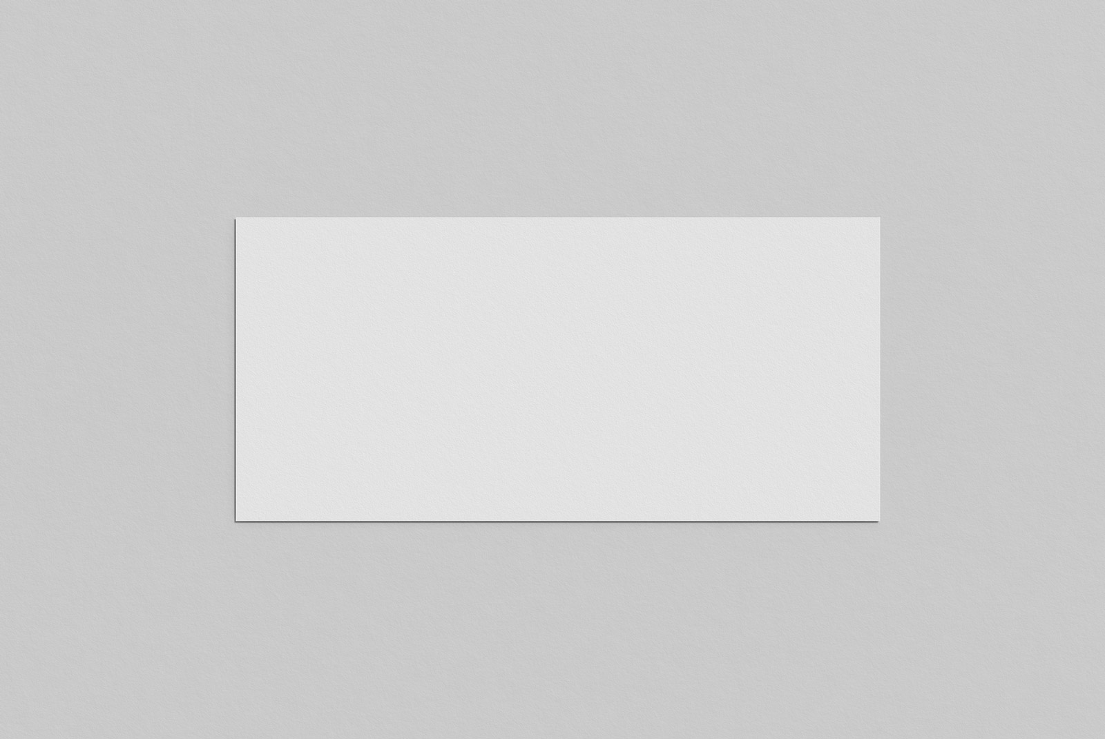 Blank paper card mockup on a textured gray background for presentation of designs and graphics.