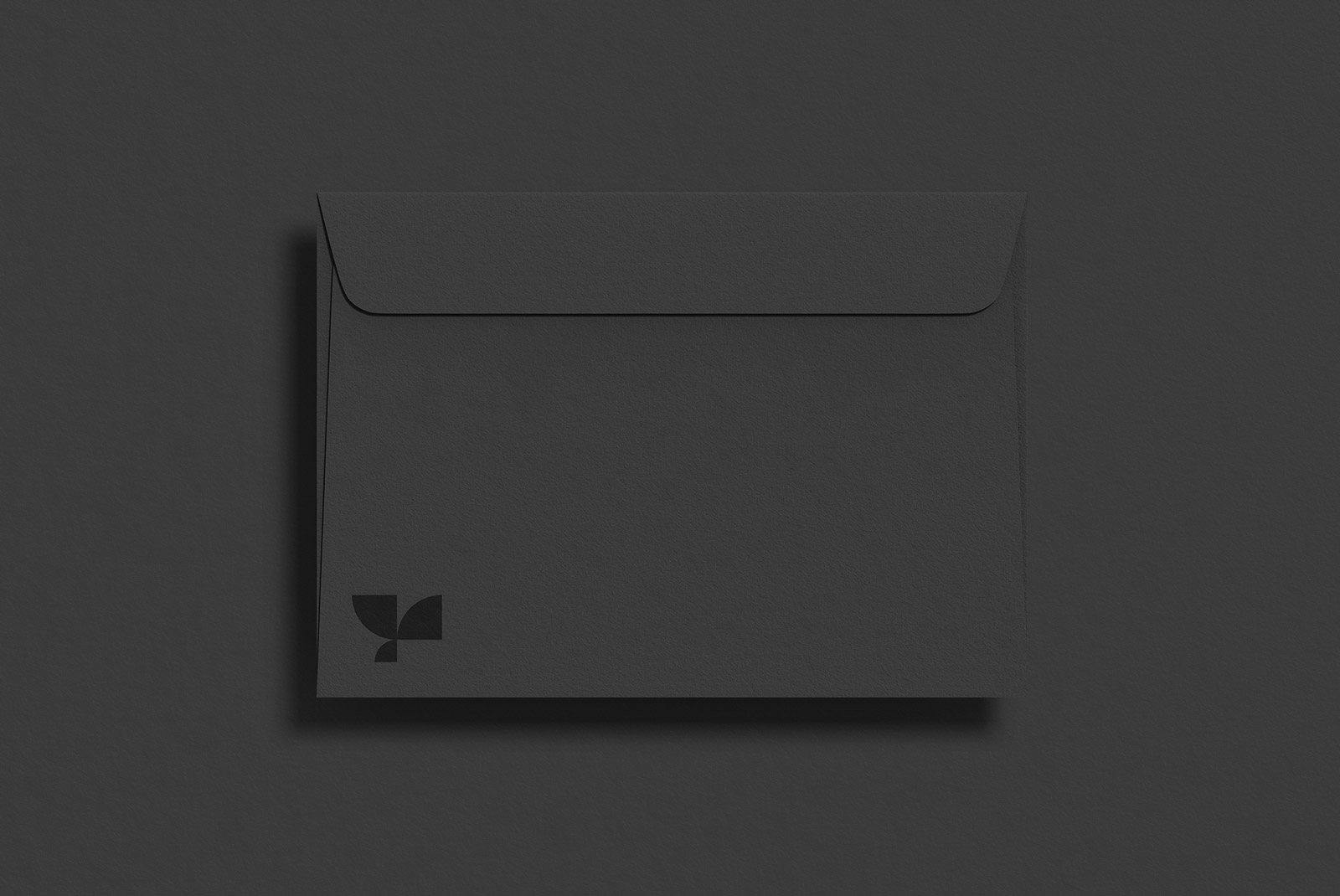 Black envelope mockup with minimalist logo on dark background, elegant presentation for stationery designs, branding assets for designers.