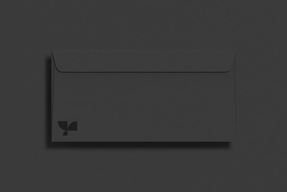 Dark charcoal envelope mockup with small logo on bottom left corner