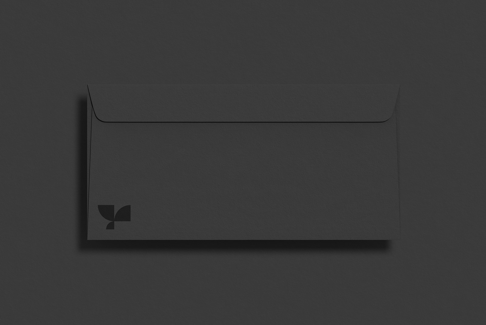 Black envelope mockup with minimalist branding on dark background, perfect for presentation and graphic design assets.