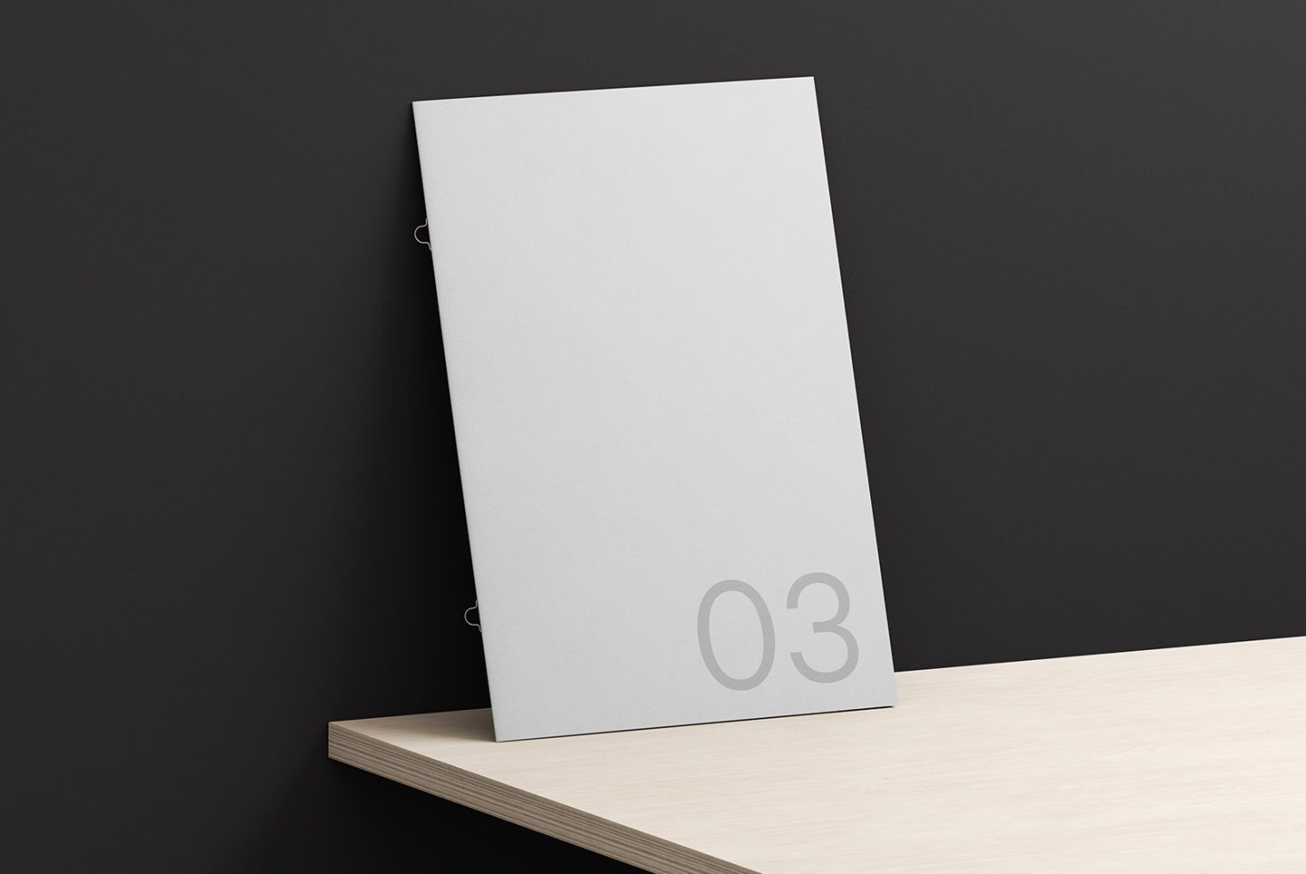 Elegant paper mockup leaning against a dark wall on a wooden shelf, with minimalistic numbering for presentation and design display.