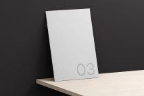 White spiral bound calendar mockup tilted on dark background with page number 03 showing