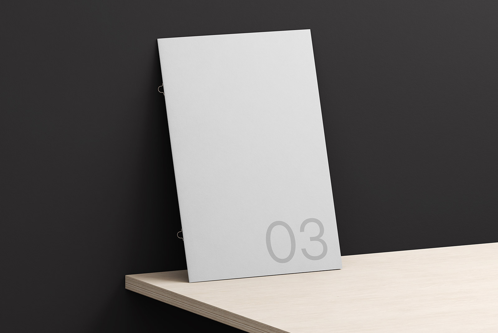 Elegant paper mockup leaning against a dark wall on a wooden shelf, with minimalistic numbering for presentation and design display.