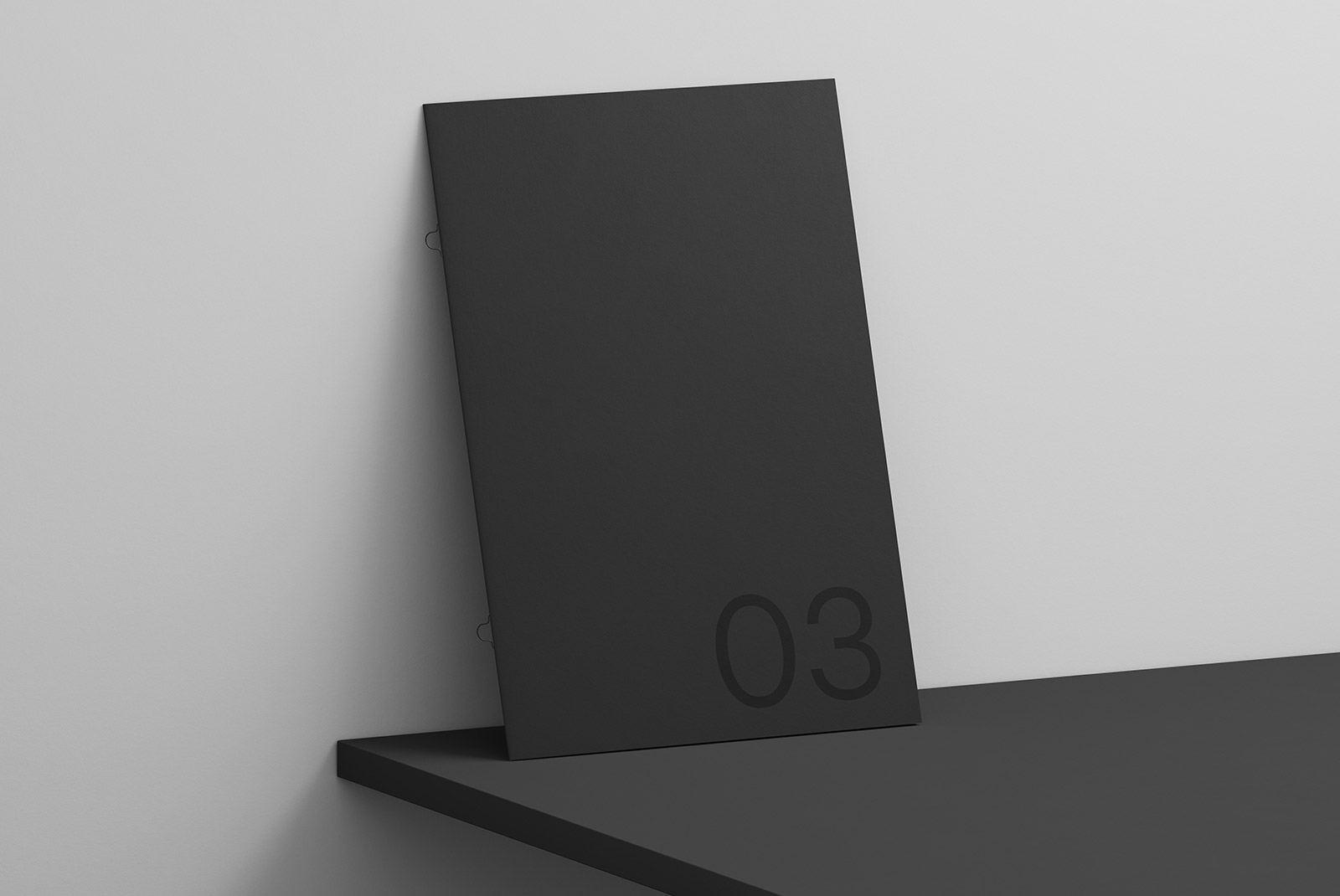 Minimalistic black folder mockup leaning on gray wall, with subtle shadow effect, ideal for sleek presentation designs, branding mockups.
