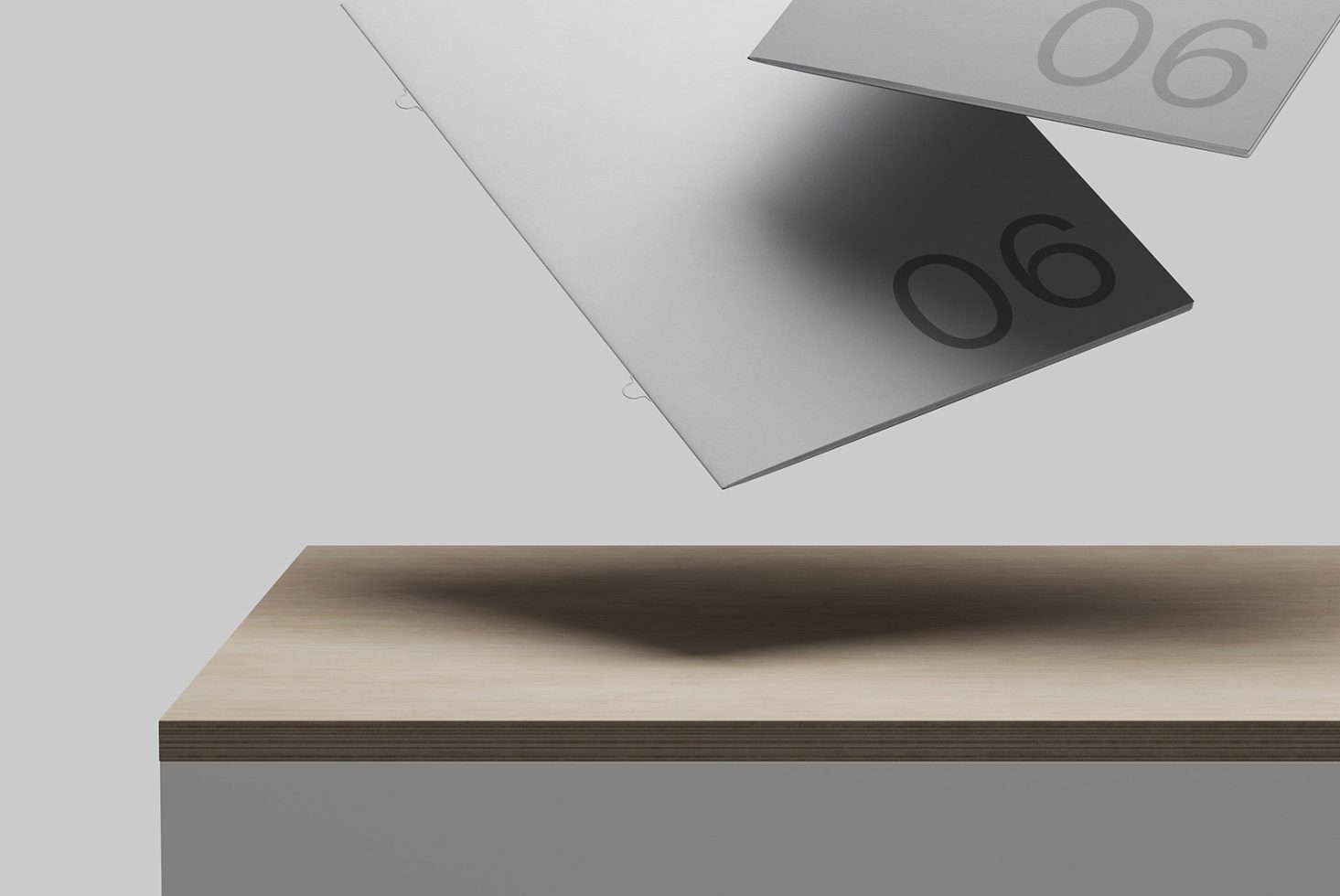 Modern stationery mockup with floating papers and shadow overlay on wooden table for graphic designers presentations.