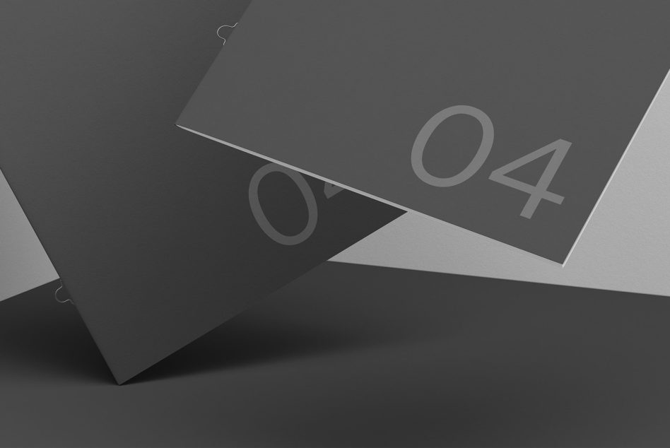 Two folded papers crossed showing numbered sides on dark background