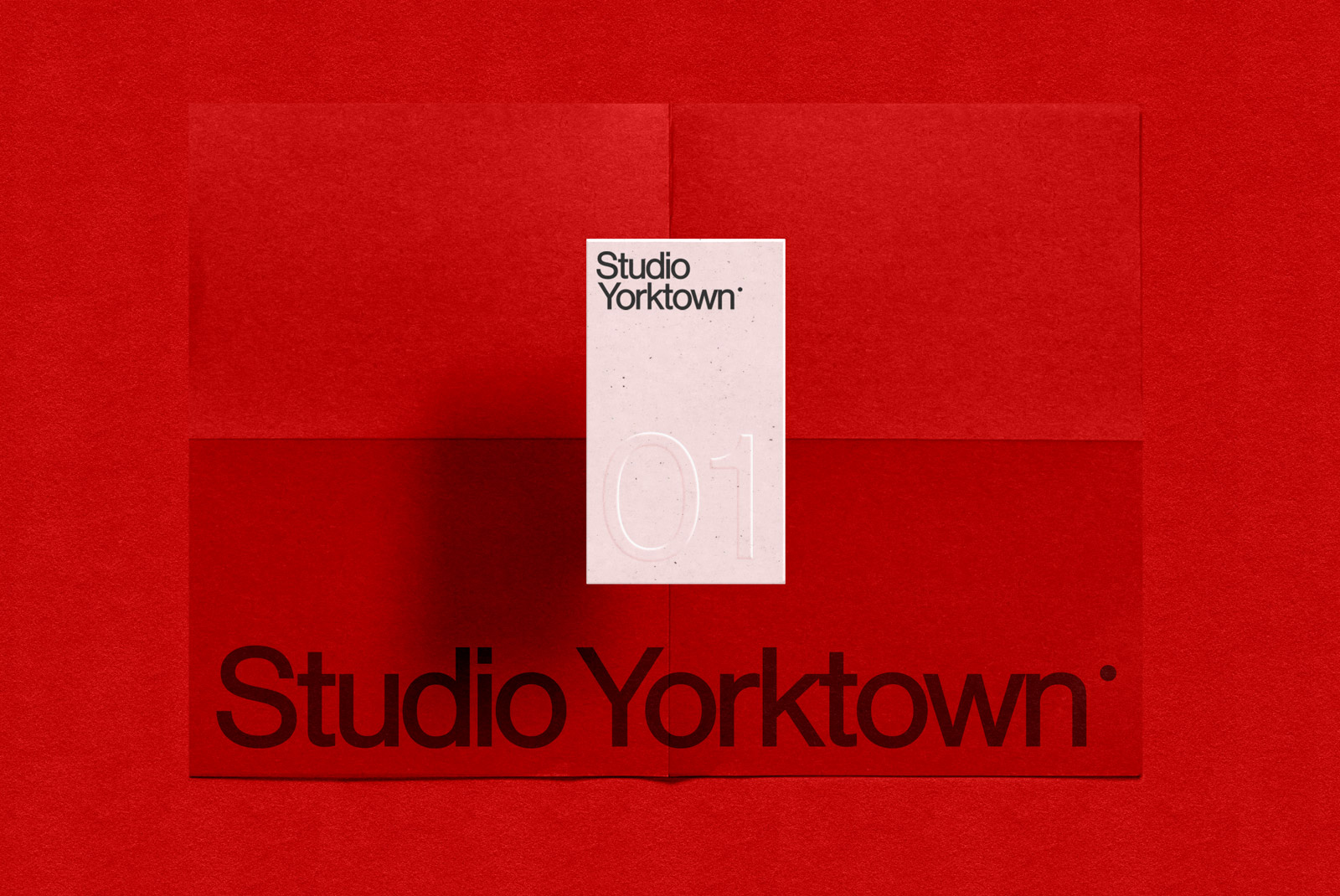 Elegant paper mockup on red textured background with embossed font showcasing Studio Yorktown design perfect for presentations and portfolios