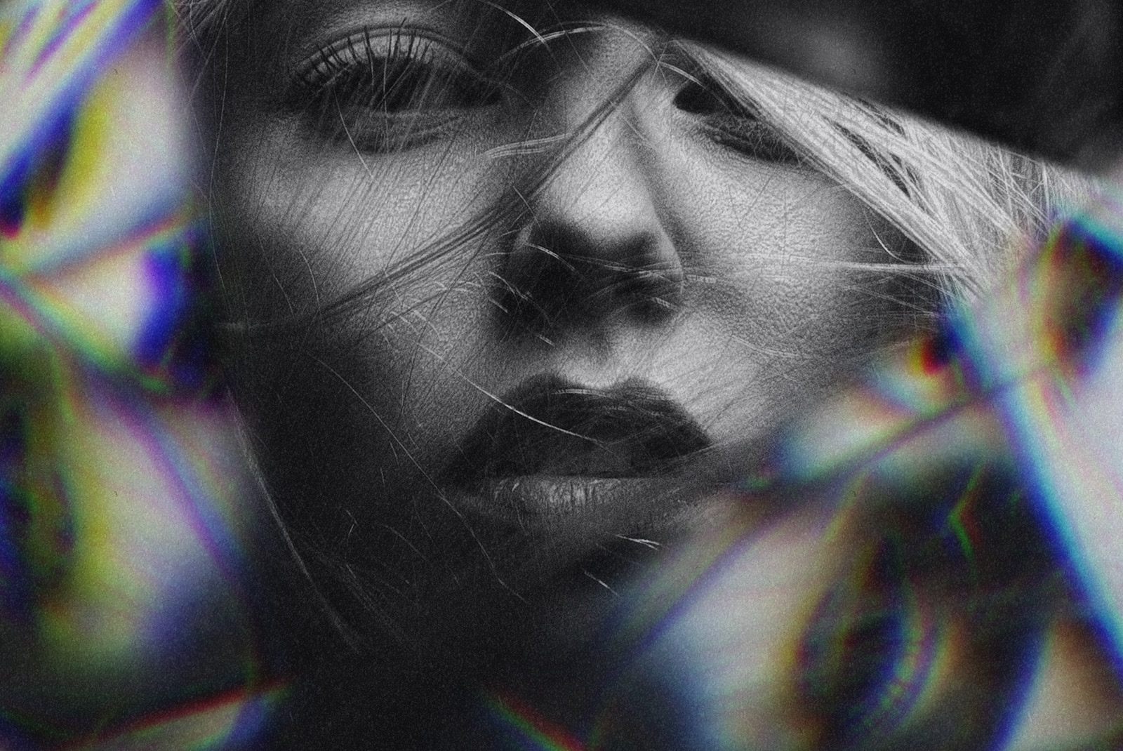 Close-up of a part of a woman's face with prism light effects, in grayscale, suitable for striking graphics or textured overlay designs.
