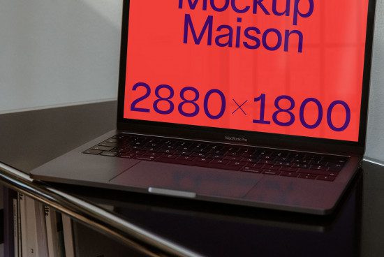 Laptop on desk showcasing screen with red Mockup Maison display, 2880x1800 resolution, professional designer digital asset.