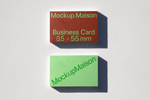 Business card mockup featuring two cards with shadows on a textured surface, ideal for presentation, design assets.