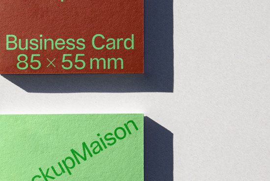 Mockup of business cards with shadow overlay, green and brown, standard size 85x55 mm, for presentation and branding design.