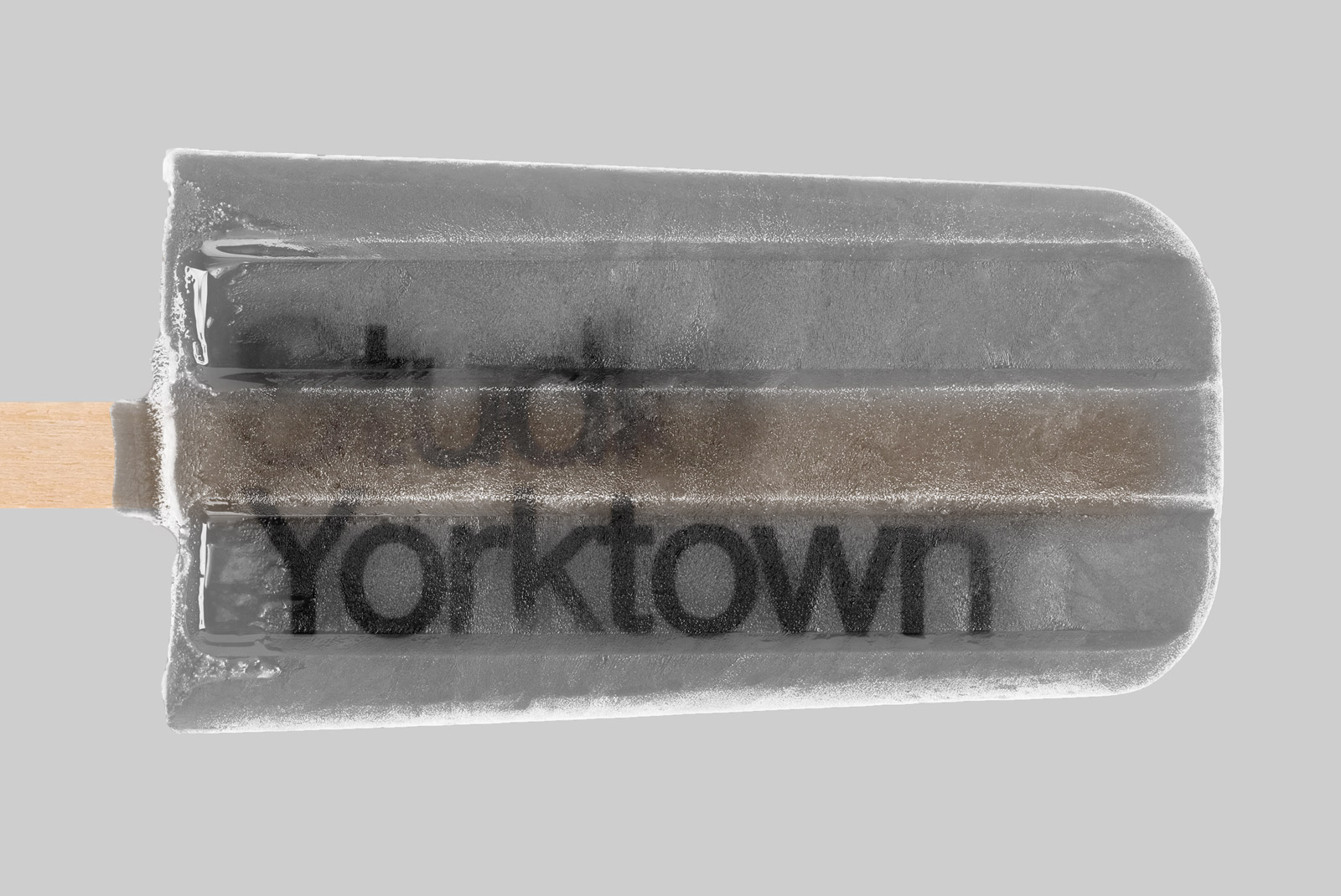 Ice pop with text "Yorktown" frozen inside, ideal for food mockups, advertising graphics, and frozen treat design templates.