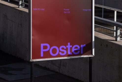 Outdoor billboard mockup displaying a red poster with purple text, ideal for designers to showcase advertising designs in a realistic urban setting.