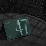 Elegant card mockup with large numerals showcasing modern font, styled on textured fabric surface against geometric background for designers.