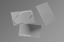 Elegant business card mockup by Orbyt Studio on a grey background, featuring silver foil stamping, perfect for presentation and design showcase.