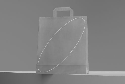 Minimalist shopping bag mockup on a gray background, showcasing space for brand design, perfect for presentations in graphic design assets.