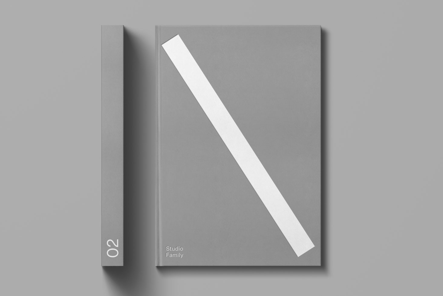 Elegant magazine mockup in light grey with a diagonal white line, perfect for presentation and design showcasing.
