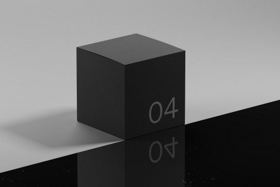 Minimalist black cube mockup with reflective surface and subtle numbering detail for graphic design presentations.