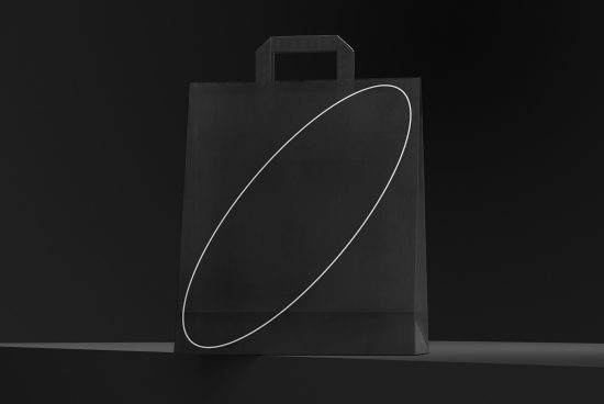 Black paper shopping bag mockup with elegant white line design on a dark background, perfect for branding and packaging presentations.