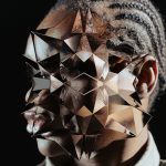 Person wearing a geometric metallic mask, artistic portrait, ideal for mockups or graphics for avant-garde design concepts.