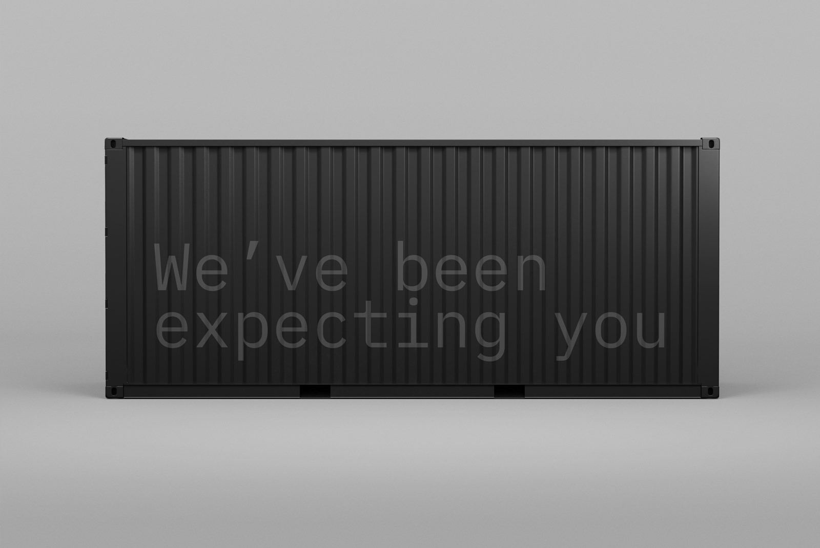 Realistic cargo container mockup with the text We've been expecting you on a grey background suitable for designers' product presentation.