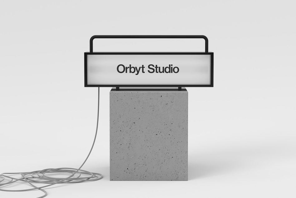 Monitor on concrete block with tangled cable, Orbyt Studio branding on screen