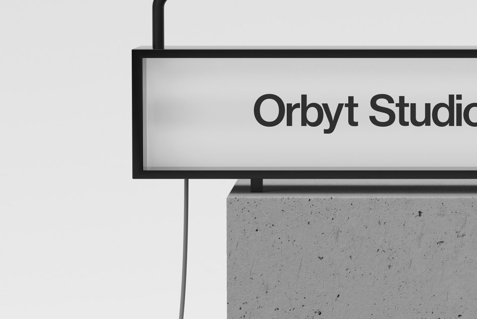 Overhead horizontal sign mockup displaying orbyt studio text clean minimal