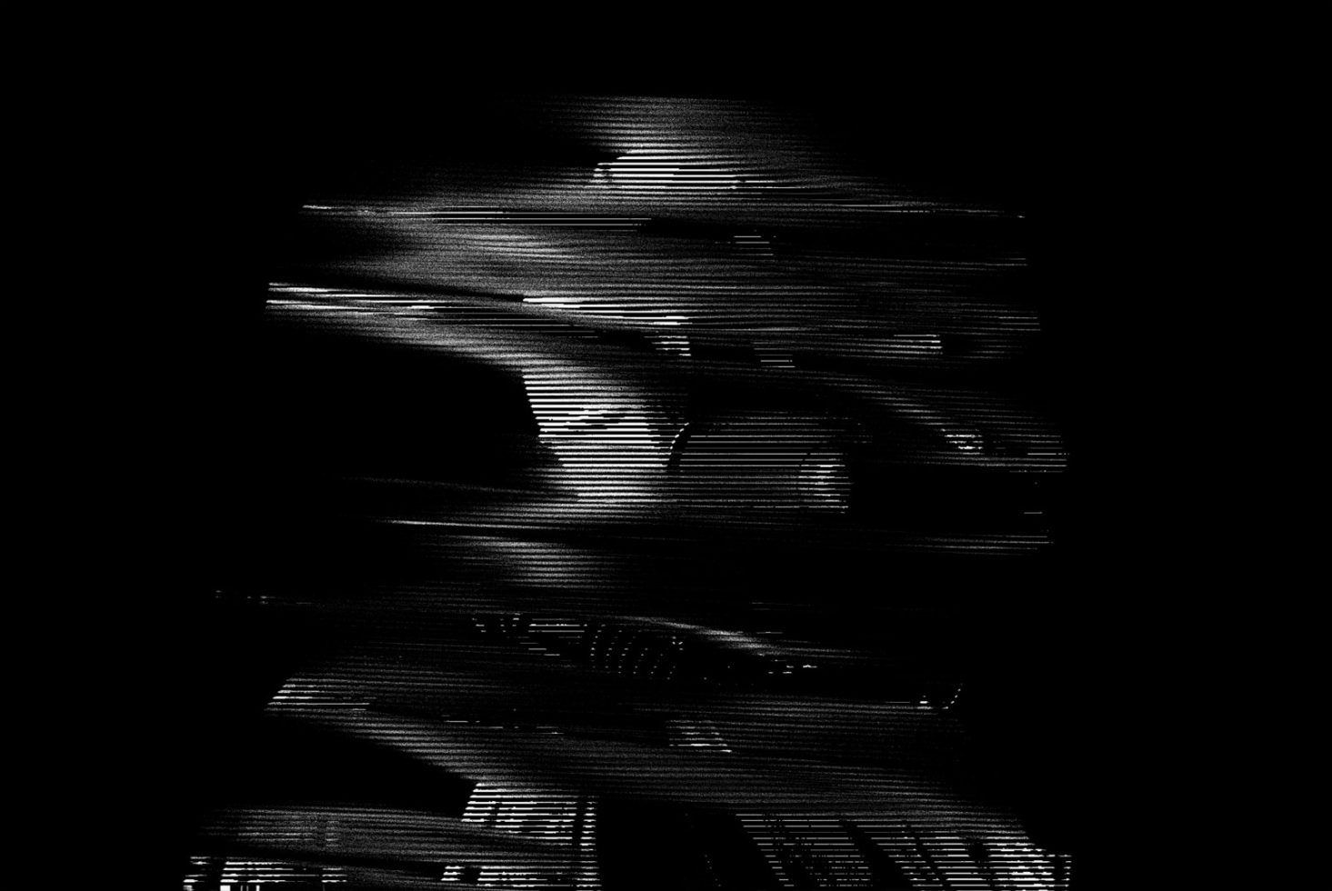 Abstract black and white distorted glitch texture for background or overlay in graphic design projects, highlighting digital corruption aesthetics.