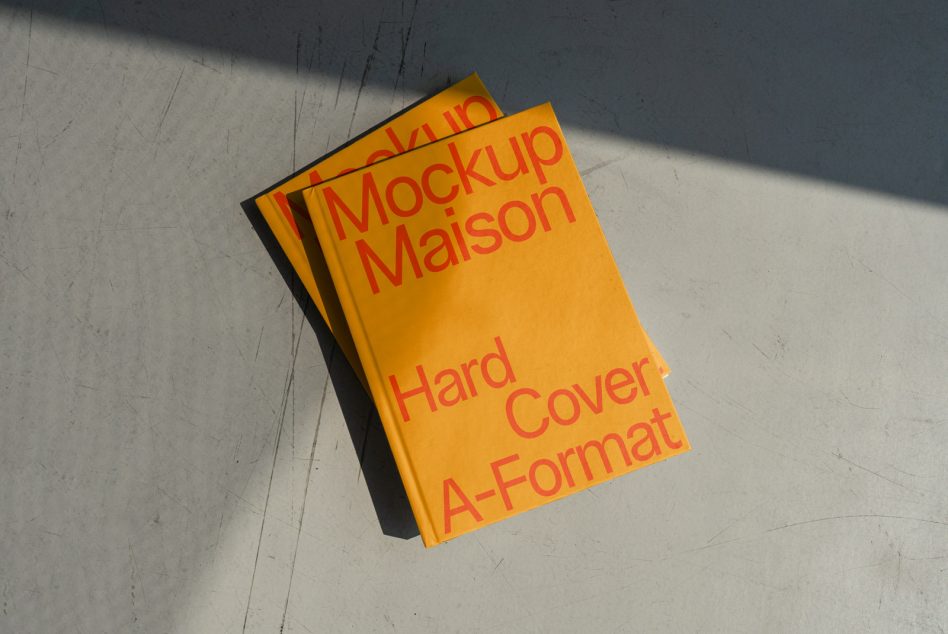 Bright orange hardcover book mockup with shadow on concrete texture, ideal for showcasing book cover designs, graphic designers asset.