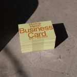 Stack of business card mockups with shadow overlay on concrete surface, ideal for graphic design and branding presentations.