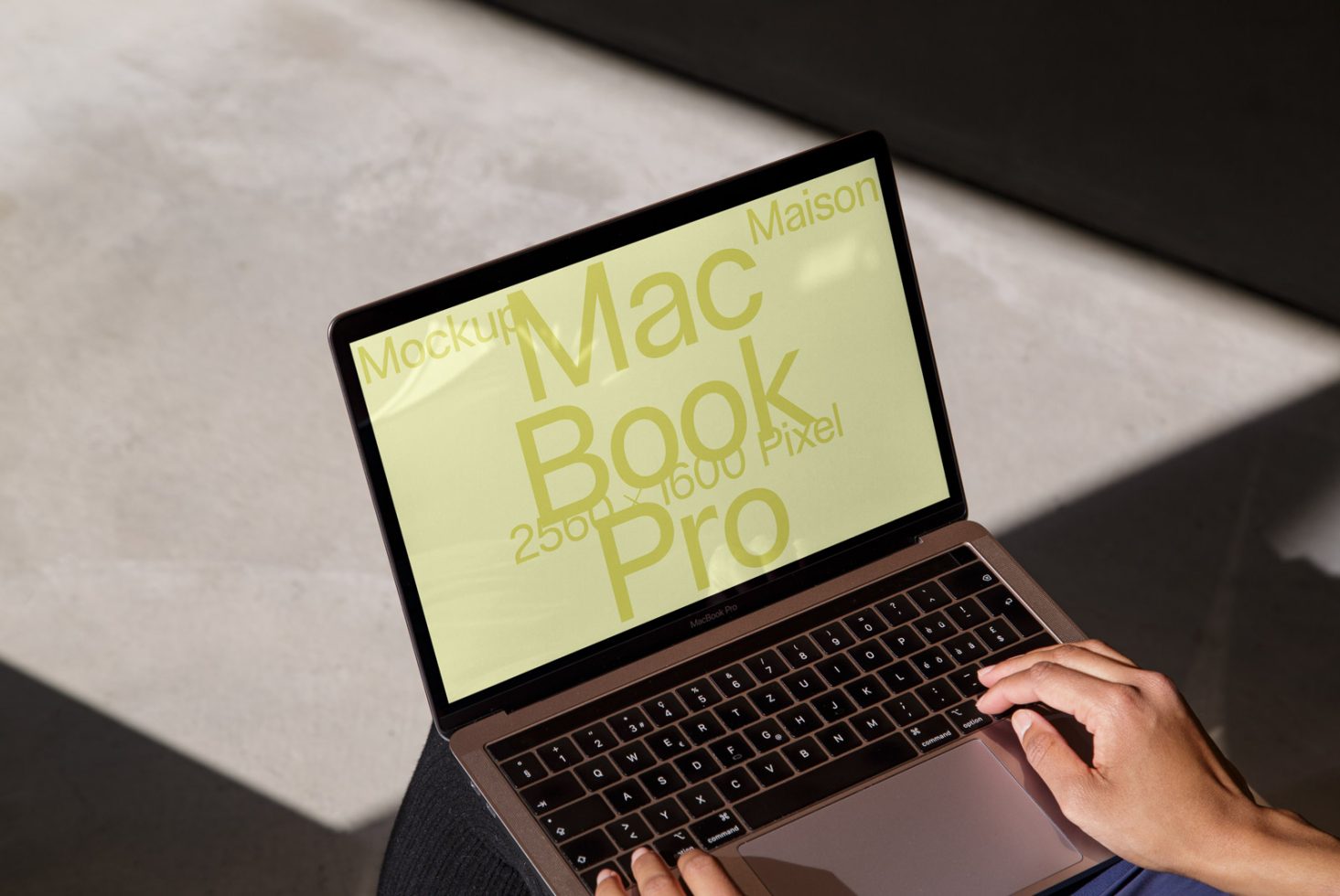 Laptop mockup on sunny desk with person using it, displaying green screen, ideal for UI design showcase, high resolution digital asset.