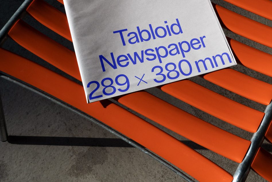 Printed tabloid newspaper mockup with dimensions on vibrant orange bench, showcasing realistic shadows and textures, ideal for media presentation.