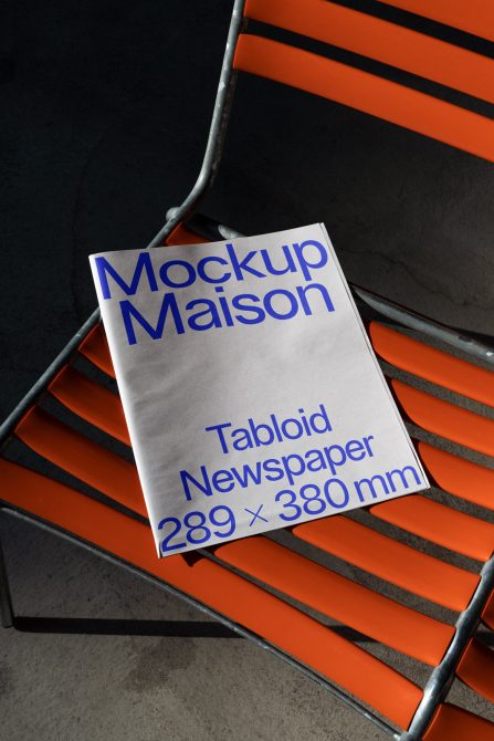 Mockup Maison Tabloid Newspaper graphic on orange chair, stylish presentation for print design, 289x380mm size for creative designers.