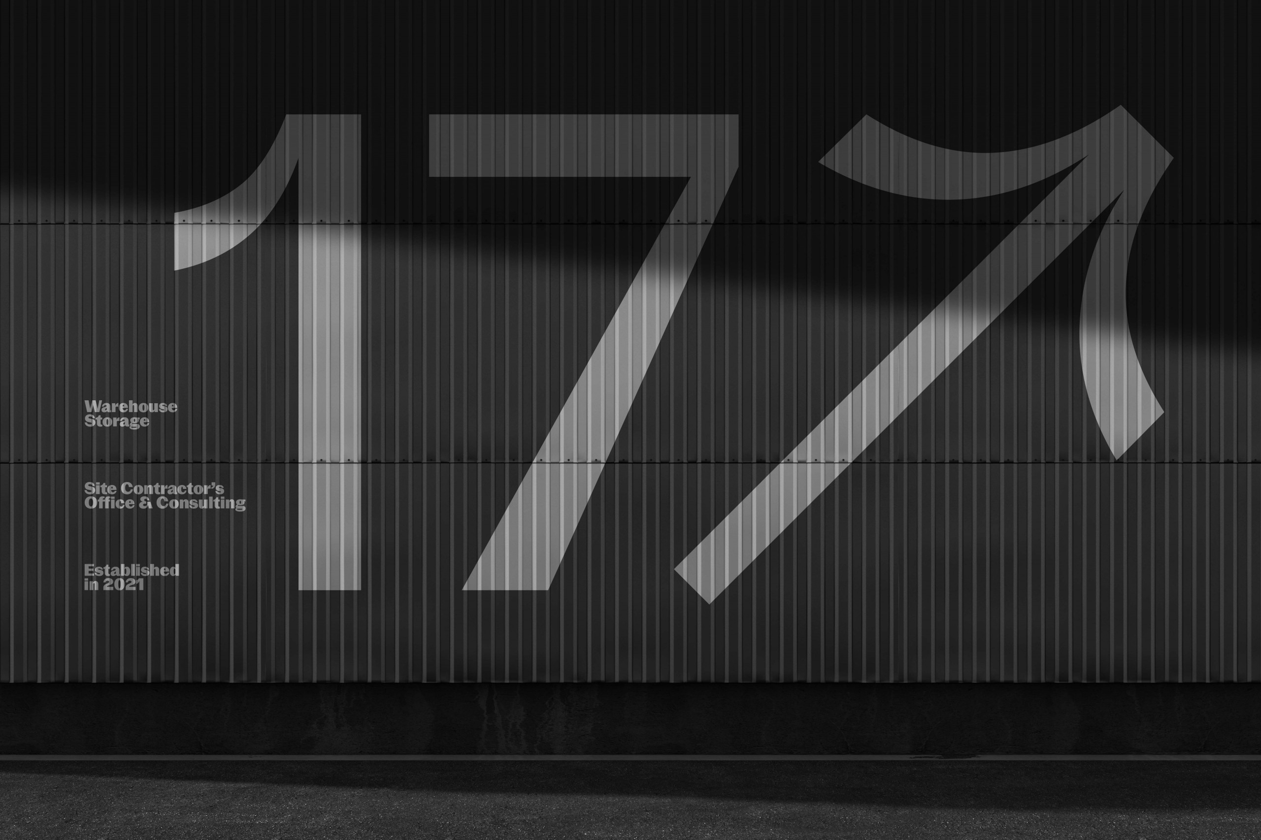 Black and white industrial wall with bold number 17 graphics, arrow design, modern typography mockup for warehouse branding.