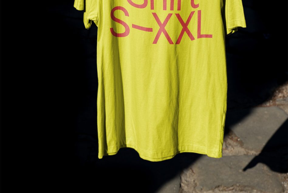 Bottom half of oversized lime green tee with size range print