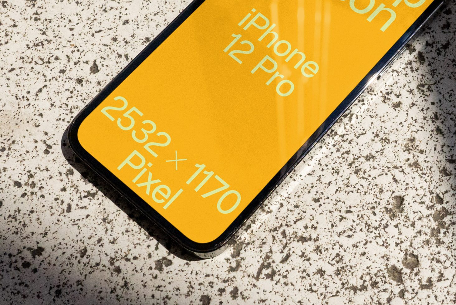 Close-up angle of iPhone 12 Pro screen mockup showing resolution on speckled surface ideal for app designers to showcase UI/UX designs.