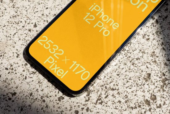 Close-up angle of iPhone 12 Pro screen mockup showing resolution on speckled surface ideal for app designers to showcase UI/UX designs.