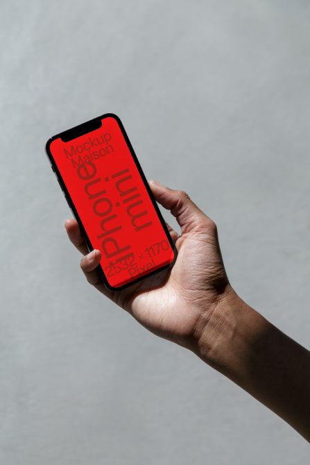 Hand holding smartphone with red screen mockup for app design display, clear background, high-resolution digital asset for designers.