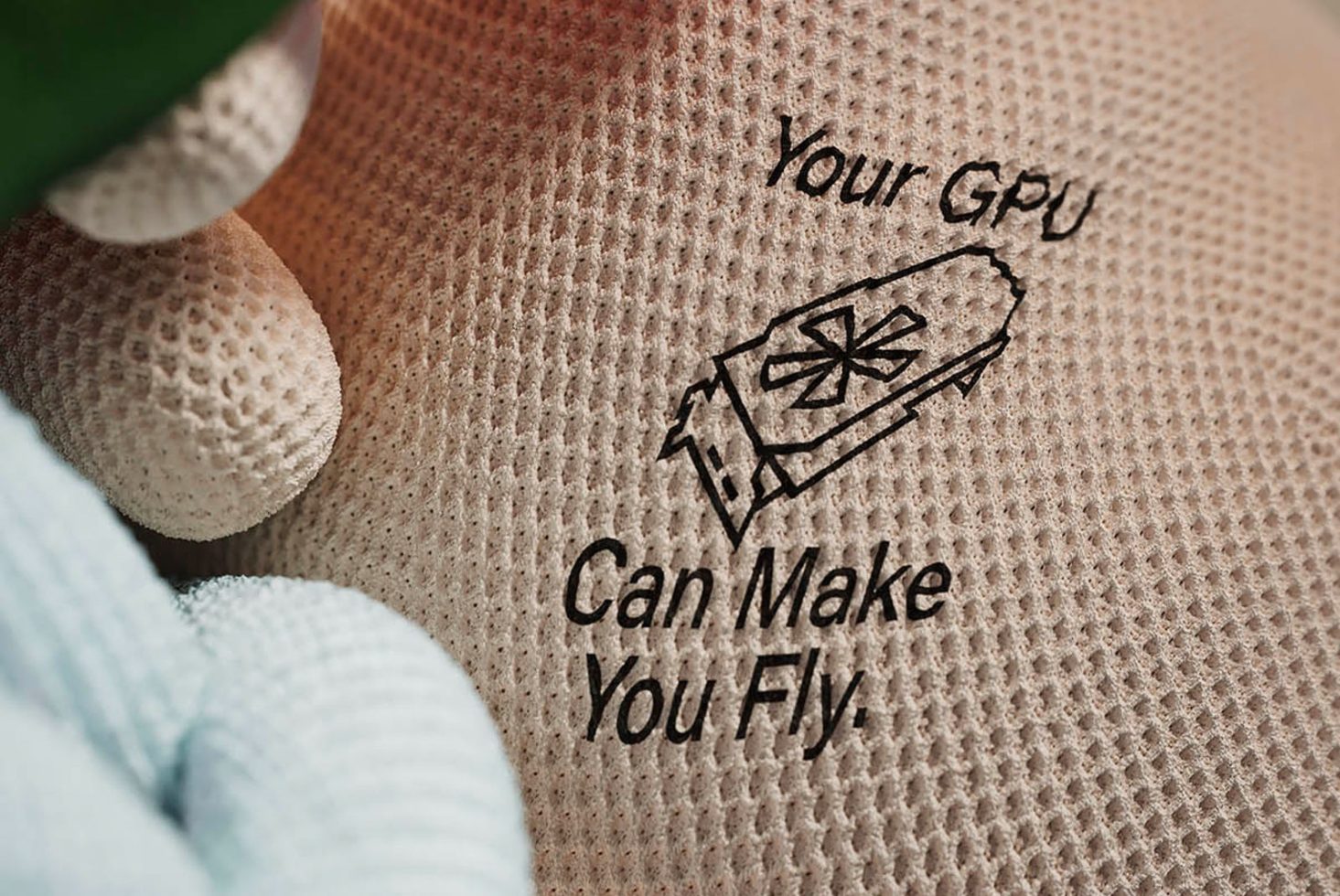 Graphic design mockup of motivational text 'Your GPU Can Make You Fly' printed on textured surface, ideal for tech-themed designs and posters.