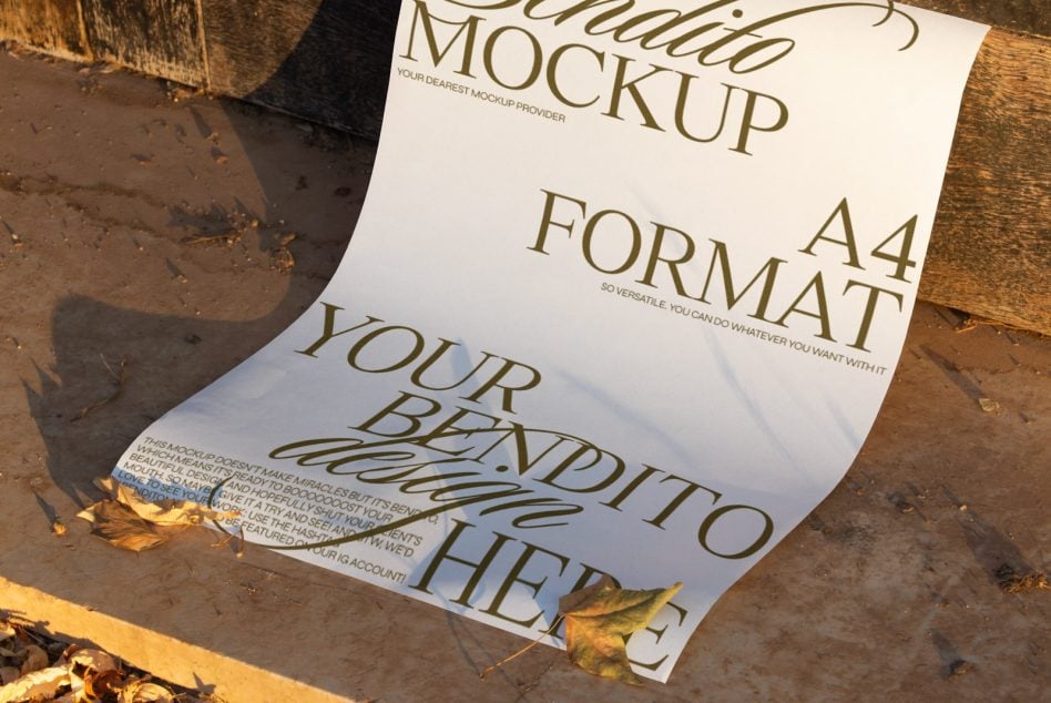 Cream A4 paper mockup with elegant serif typography on wet concrete, gold leaves scattered around