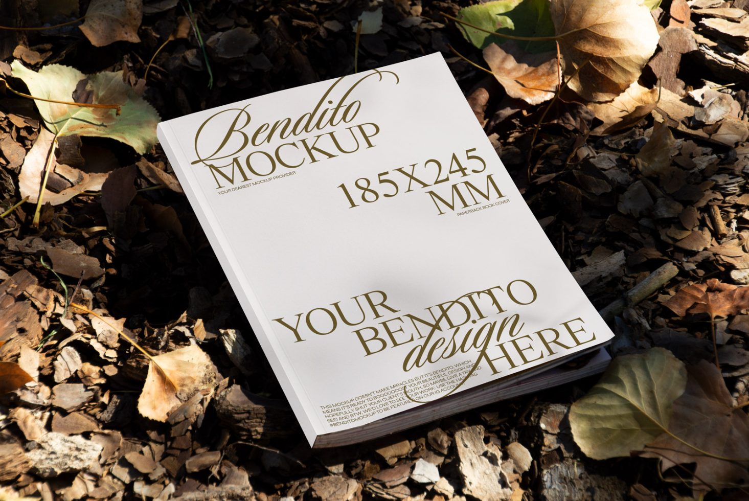 Paperback book mockup lying on a bed of autumn leaves, showcasing customizable cover design for designers, suitable for graphic presentations.