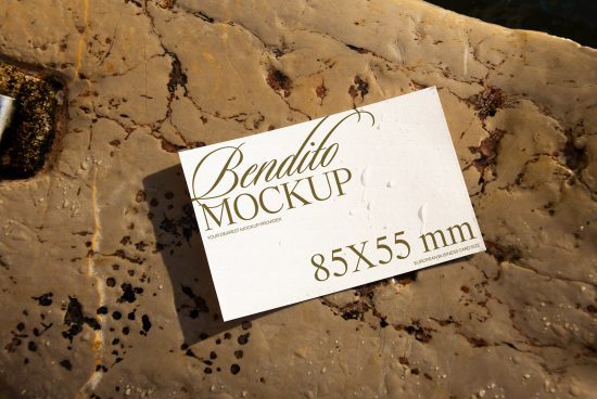 ALT: Business card mockup lying on textured stone surface, showing design sample for branding and identity for designers to visualize their work.