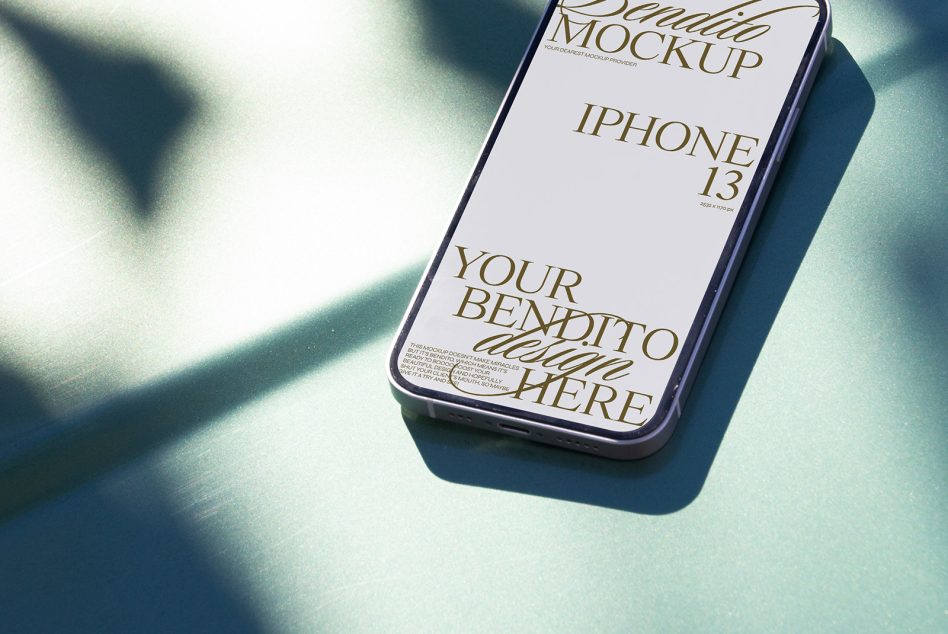 Stylish iPhone 13 mockup on green shadowed surface, ideal for showcasing app designs and mobile interfaces for graphic designers.