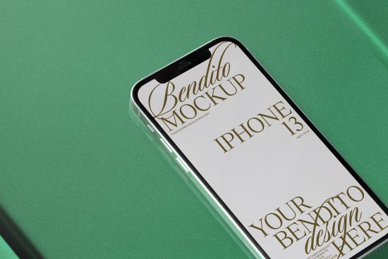 Elegant iPhone 13 mockup on green surface displaying ornate script font, ideal for showcasing app designs or mobile interface layouts.