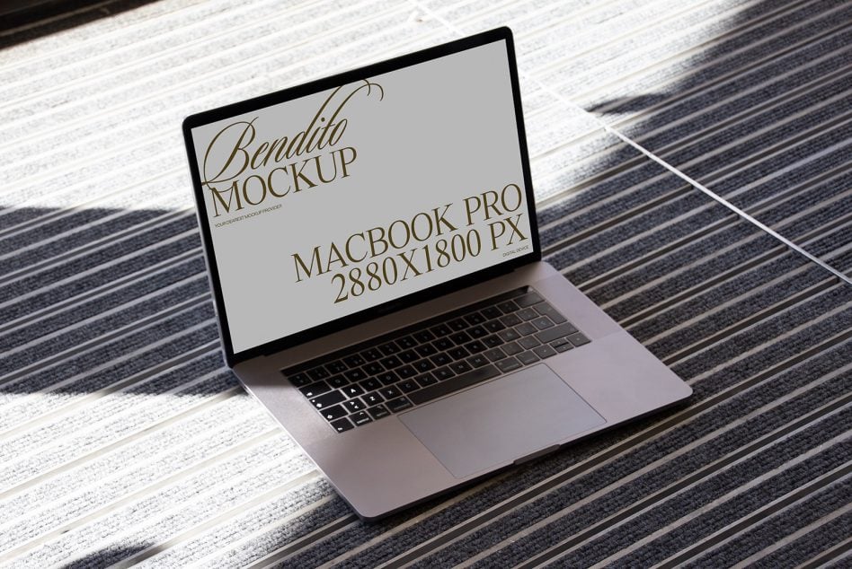 MacBook Pro 16 on mixed wood texture with serif font mockup on screen