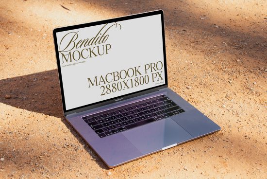 Laptop mockup on sandy ground showcasing screen for design presentation, MacBook Pro digital device, designers' asset.
